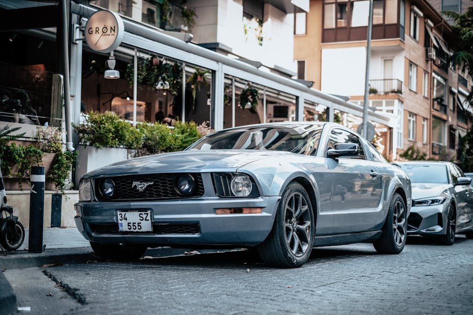 Vintage sports car parked in a city street, showcasing urban lifestyle and automotive style