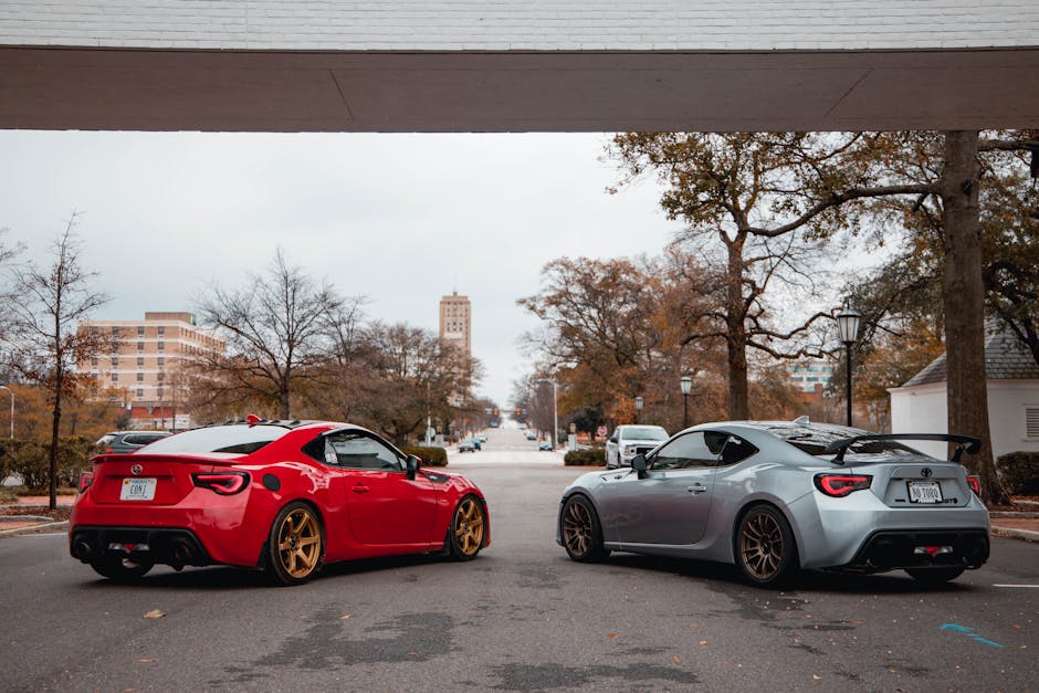 Modern sports cars parked under bridge, urban setting, winter