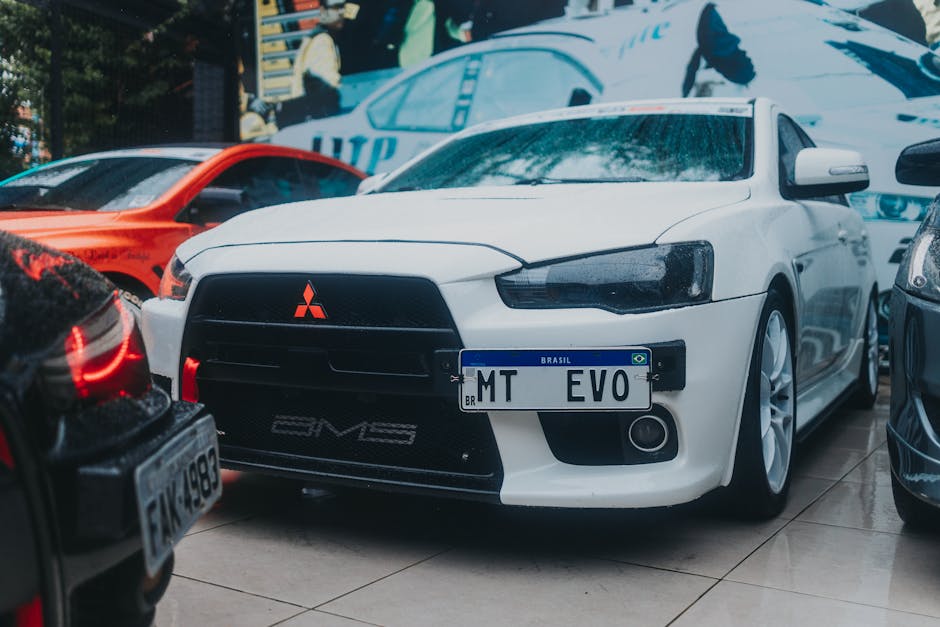 Close-up of a white Mitsubishi Lancer Evo parked outdoors with a Brazilian license plate